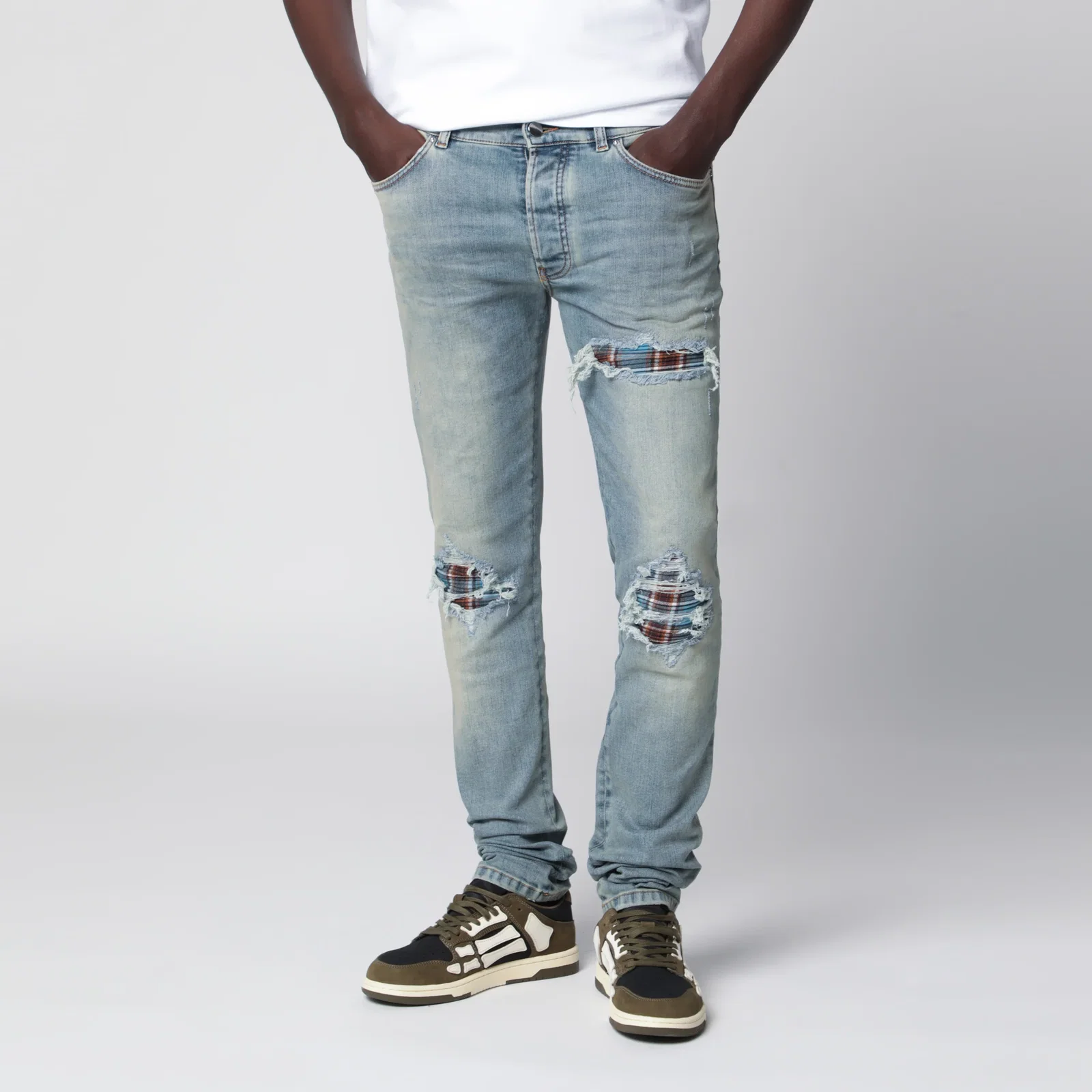 AMIRI MX1 distressed flannel-patched jeans in medium indigo